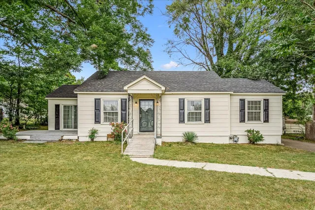 a front view of a house with a yard