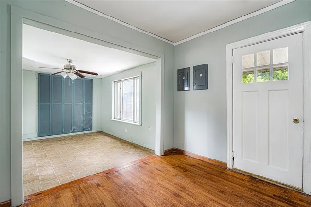 a view of empty room with window and wooden floor
