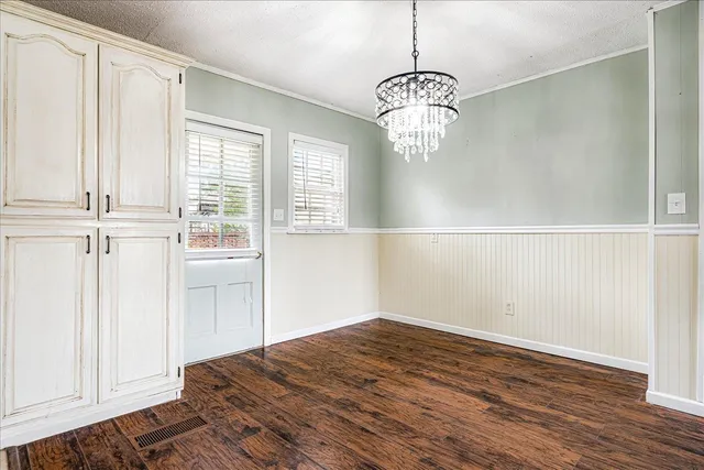 a view of a room with wooden floor and windows