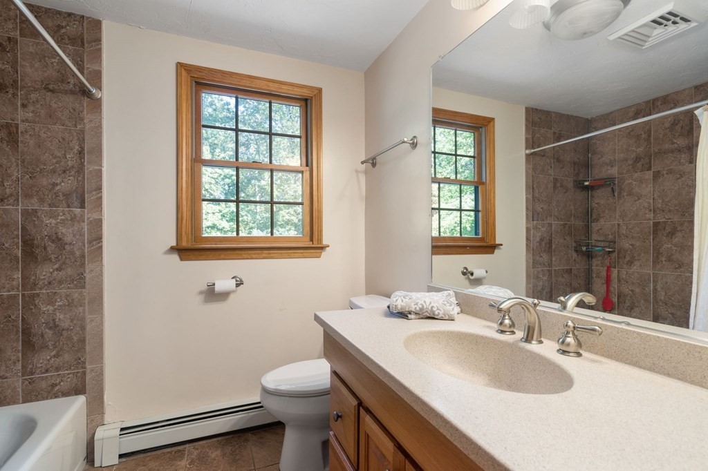 22 Robbin Road Canton, MA 02021 - Photo 34 of 40 a bathroom with a granite countertop sink toilet and shower