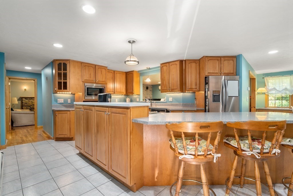 22 Robbin Road Canton, MA 02021 - Photo 5 of 40 a kitchen with stainless steel appliances granite countertop a refrigerator and microwave