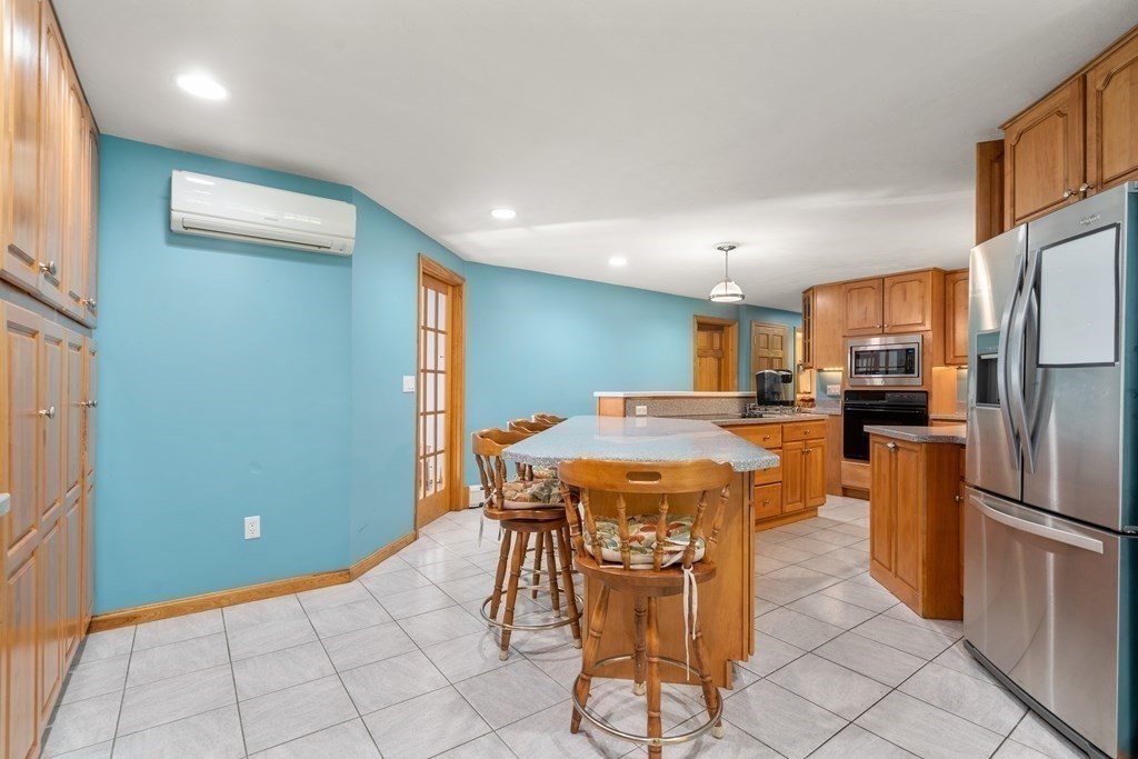 22 Robbin Road Canton, MA 02021 - Photo 7 of 40 a dining hall with a dining table and chairs