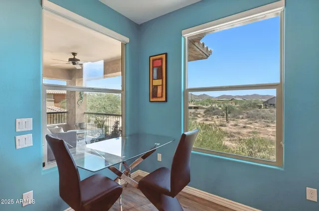 a kitchen with stainless steel appliances granite countertop a stove top oven a sink dishwasher and a microwave oven with white cabinets