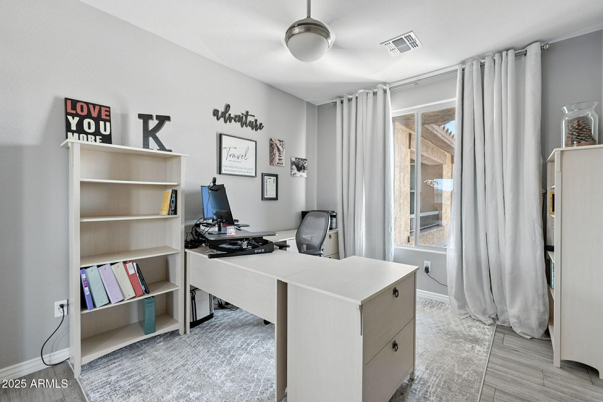 2425 West Bronco Butte Trail, Unit 2014 Phoenix, AZ 85085 - Photo 18 of 32 a living room with a couch and a bookshelf