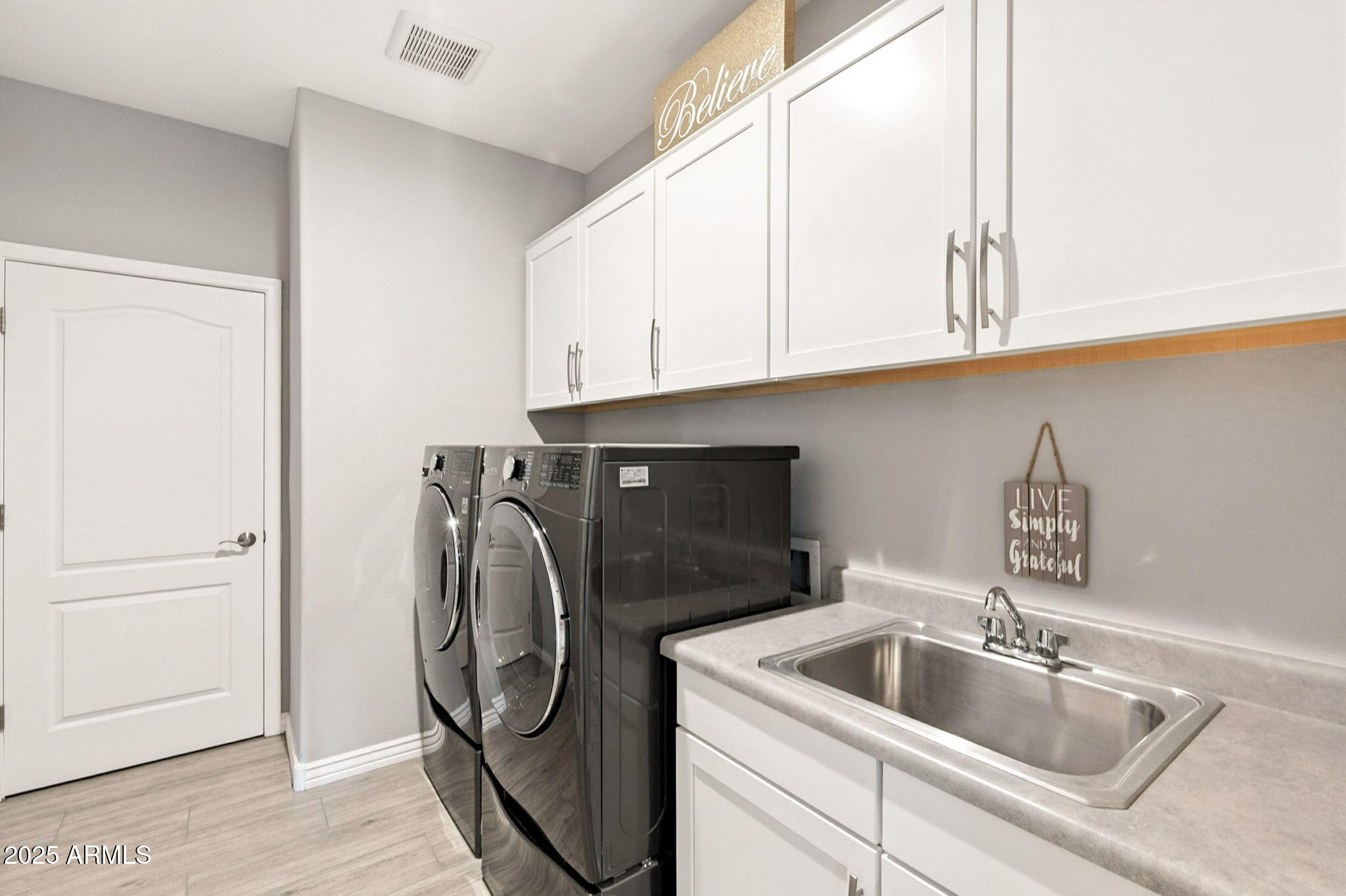 2425 West Bronco Butte Trail, Unit 2014 Phoenix, AZ 85085 - Photo 30 of 32 a kitchen with a sink and cabinets