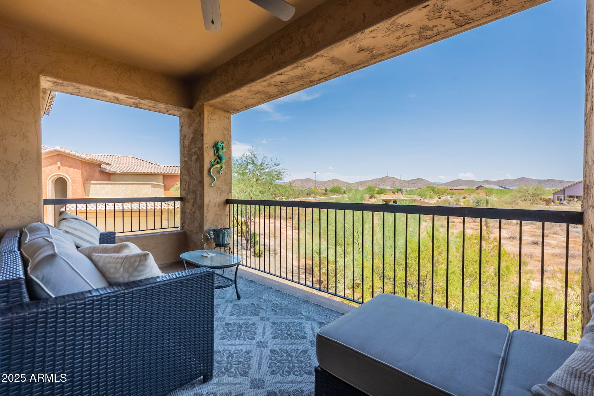 2425 West Bronco Butte Trail, Unit 2014 Phoenix, AZ 85085 - Photo 31 of 32 a balcony with furniture and wooden floor