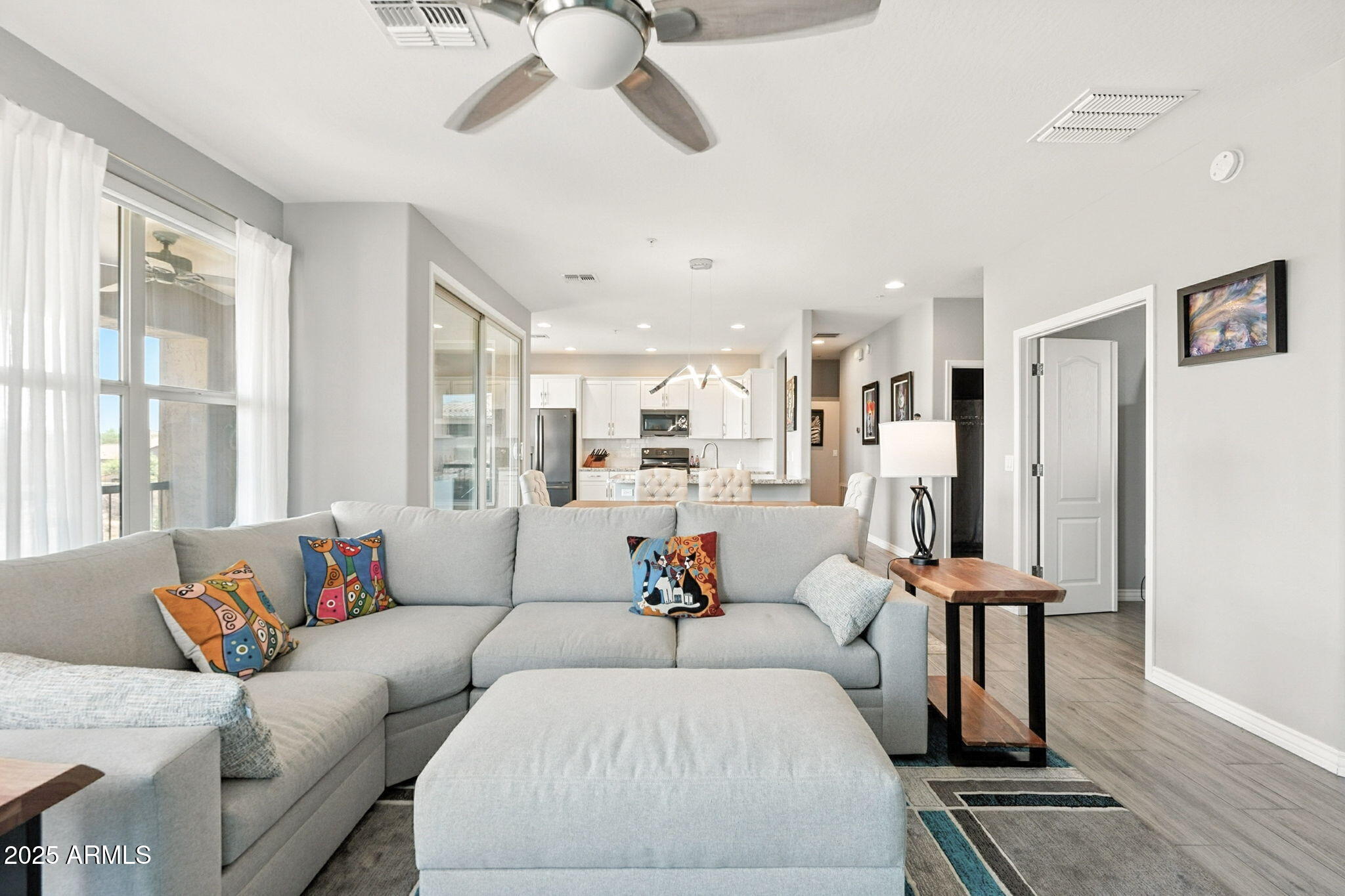 2425 West Bronco Butte Trail, Unit 2014 Phoenix, AZ 85085 - Photo 6 of 32 a living room with furniture wooden floor and a large window