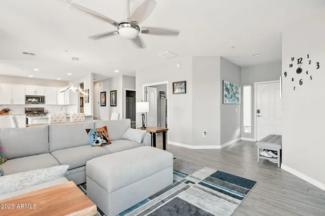 a living room with furniture and kitchen view