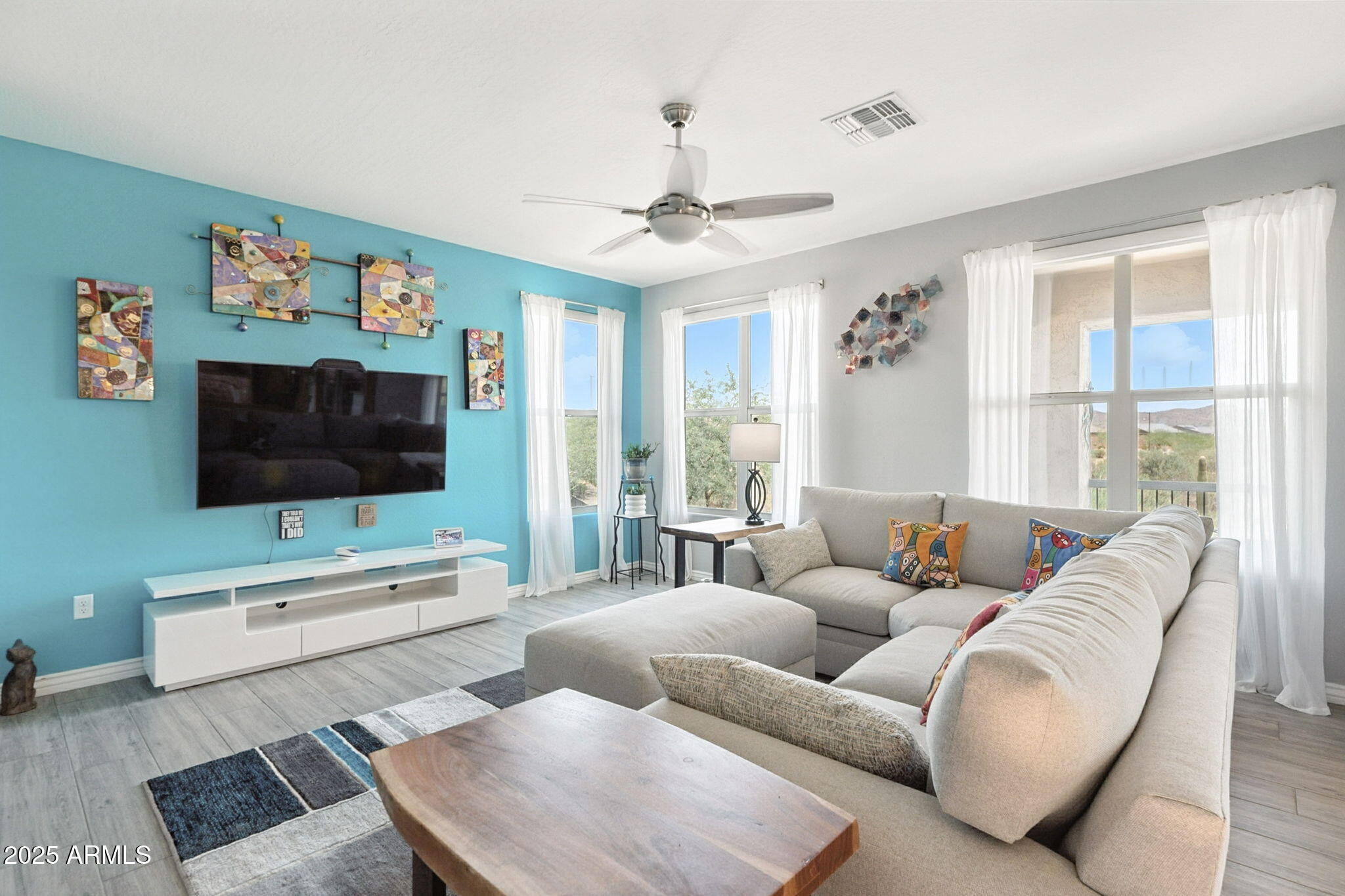 2425 West Bronco Butte Trail, Unit 2014 Phoenix, AZ 85085 - Photo 8 of 32 a living room with furniture and a flat screen tv