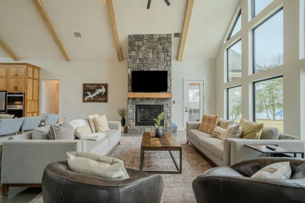a living room with furniture fireplace and a large window