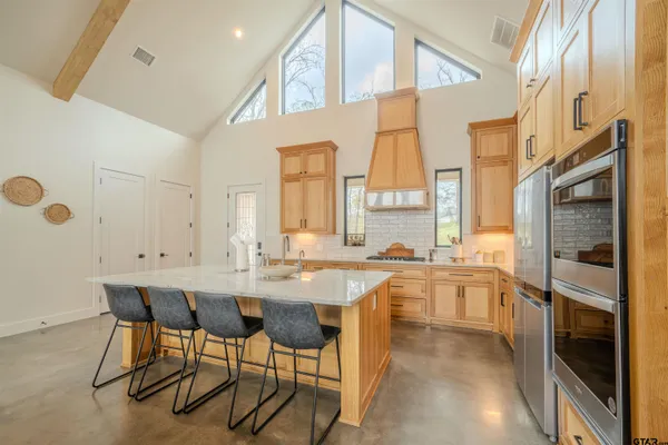 a large white kitchen with a large window