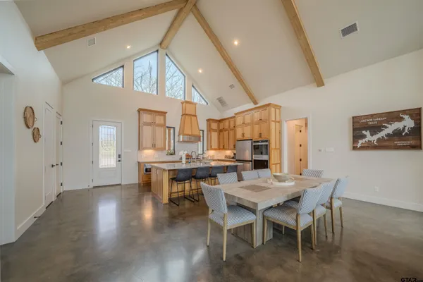 a living room with furniture a fireplace and a floor to ceiling window