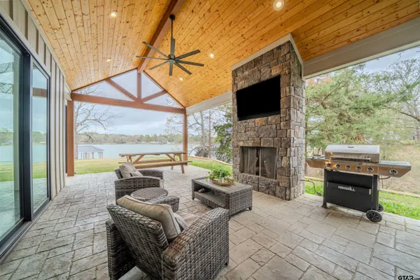 a backyard of a house with swimming pool table and chairs