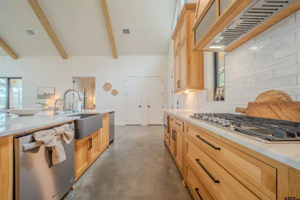 a kitchen with stainless steel appliances granite countertop a stove and a sink