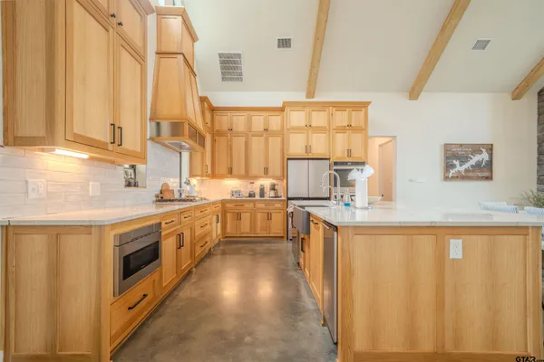 a kitchen with stainless steel appliances a sink counter space and a window