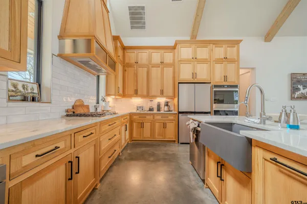 a kitchen with cabinets a sink and appliances