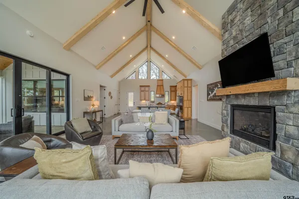 a living room with furniture a fireplace and a flat screen tv
