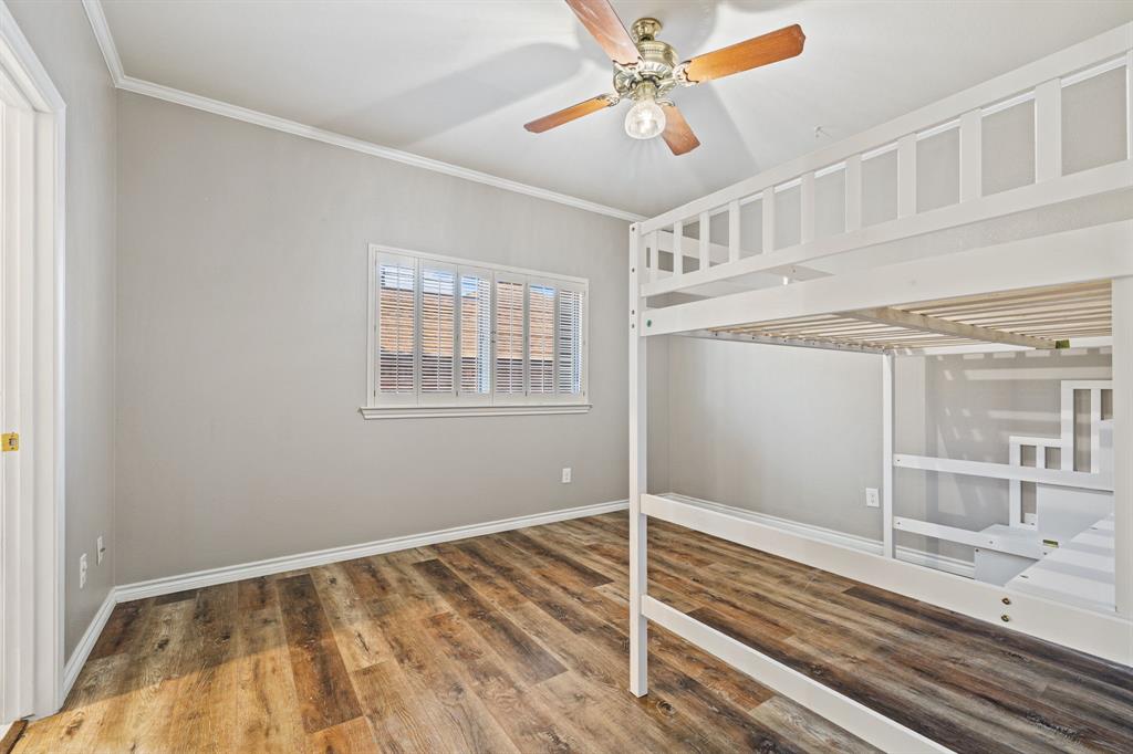 4134 Crossing Lane Dallas, TX 75220 - Photo 24 of 39 Unfurnished bedroom featuring wood finished floors, ornamental molding, and a ceiling fan