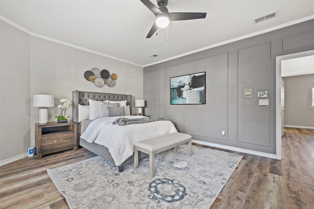 4134 Crossing Lane Dallas, TX 75220 - Photo 34 of 39 Bedroom featuring crown molding, a ceiling fan, wood finished floors, and a decorative wall