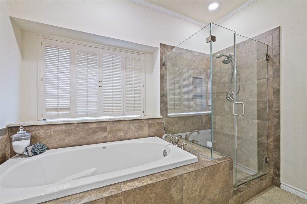 4134 Crossing Lane Dallas, TX 75220 - Photo 38 of 39 Full bathroom with a stall shower, a garden tub, and ornamental molding