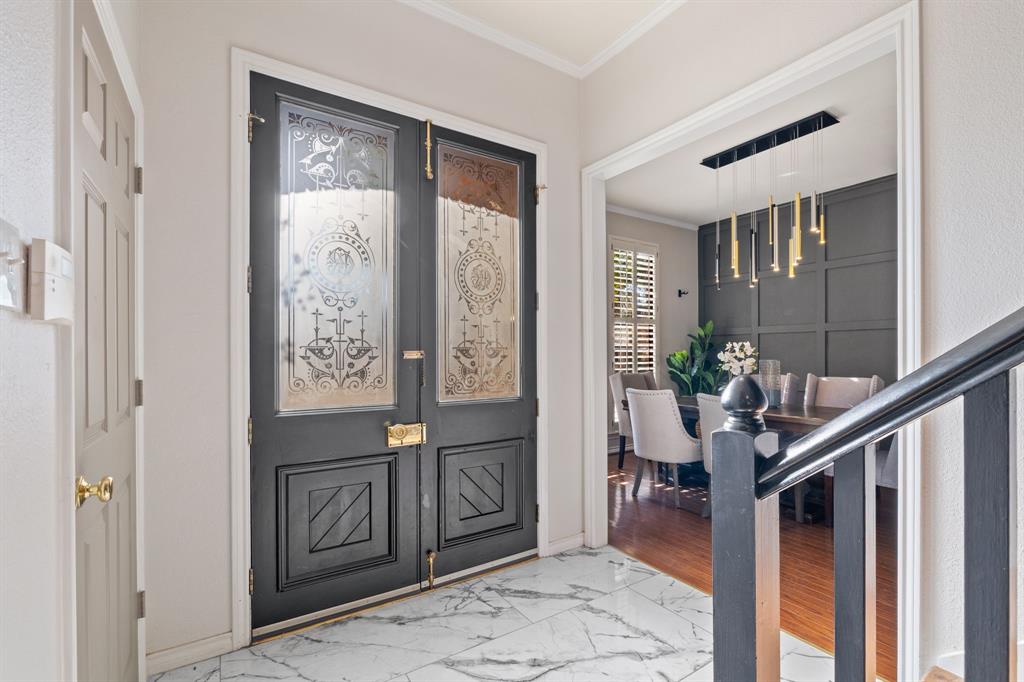 4134 Crossing Lane Dallas, TX 75220 - Photo 5 of 39 Entryway featuring light marble finish floors and crown molding