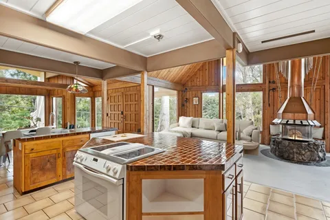 a kitchen with a stove and large window