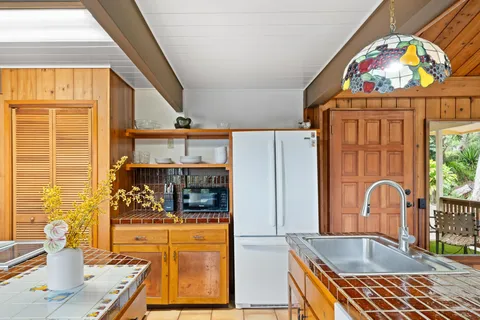 a kitchen with stainless steel appliances kitchen island granite countertop a refrigerator and a stove