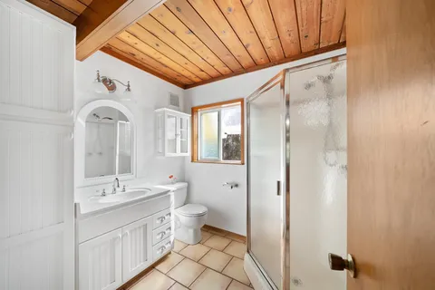 a bathroom with a double vanity sink mirror and toilet