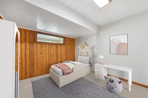 a spacious bedroom with a bed and a window