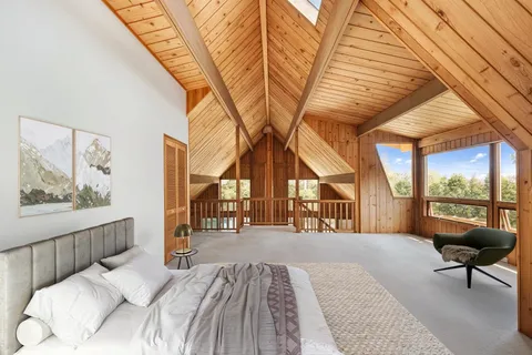 a bedroom with a bed and a large window