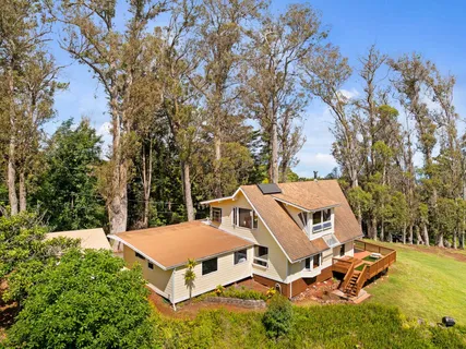 an aerial view of a house with yard table and chairs