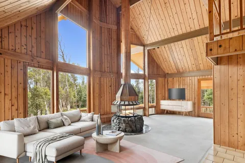 a living room with furniture a rug and a large window