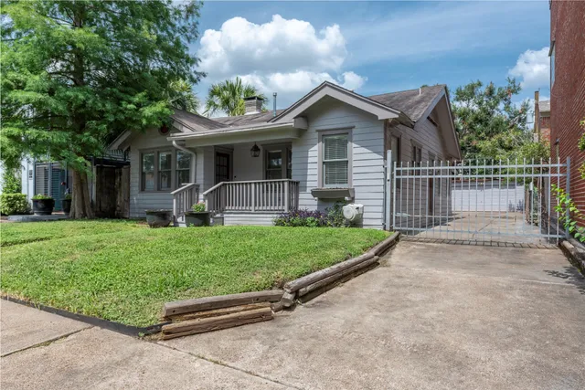 a front view of a house with a garden and yard