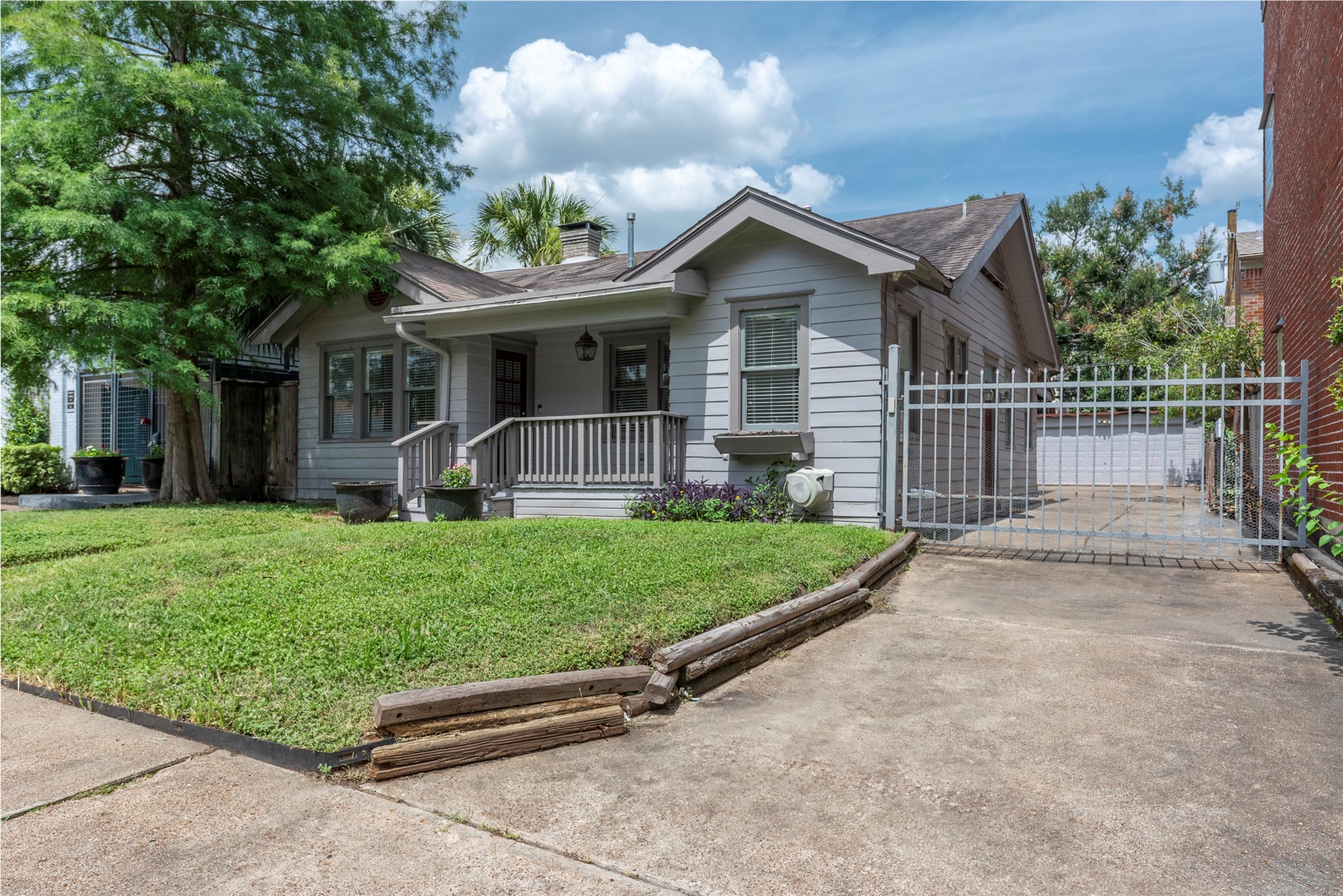 a front view of a house with a garden and yard