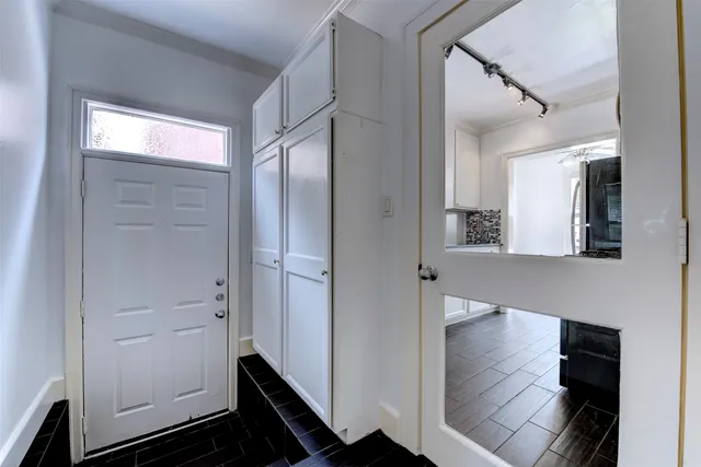 a view of an entryway with wooden floor