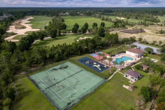 an aerial view of residential houses with outdoor space and river