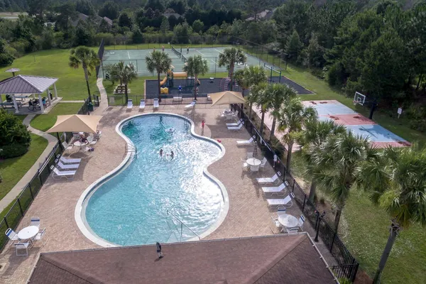 a view of a swimming pool with a patio and a garden