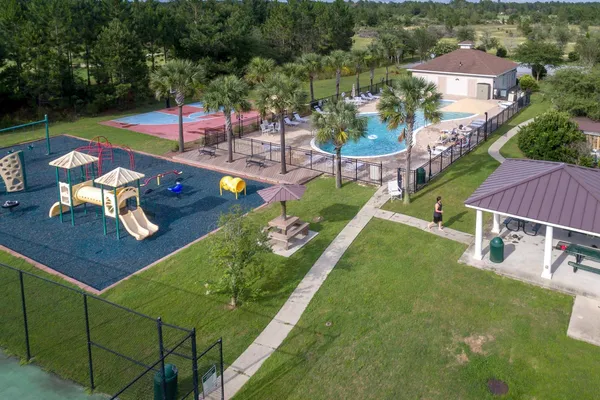 an aerial view of a house with swimming pool garden and patio