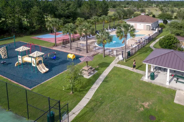 an aerial view of a house with swimming pool garden and patio