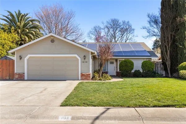 a front view of house with yard and trees