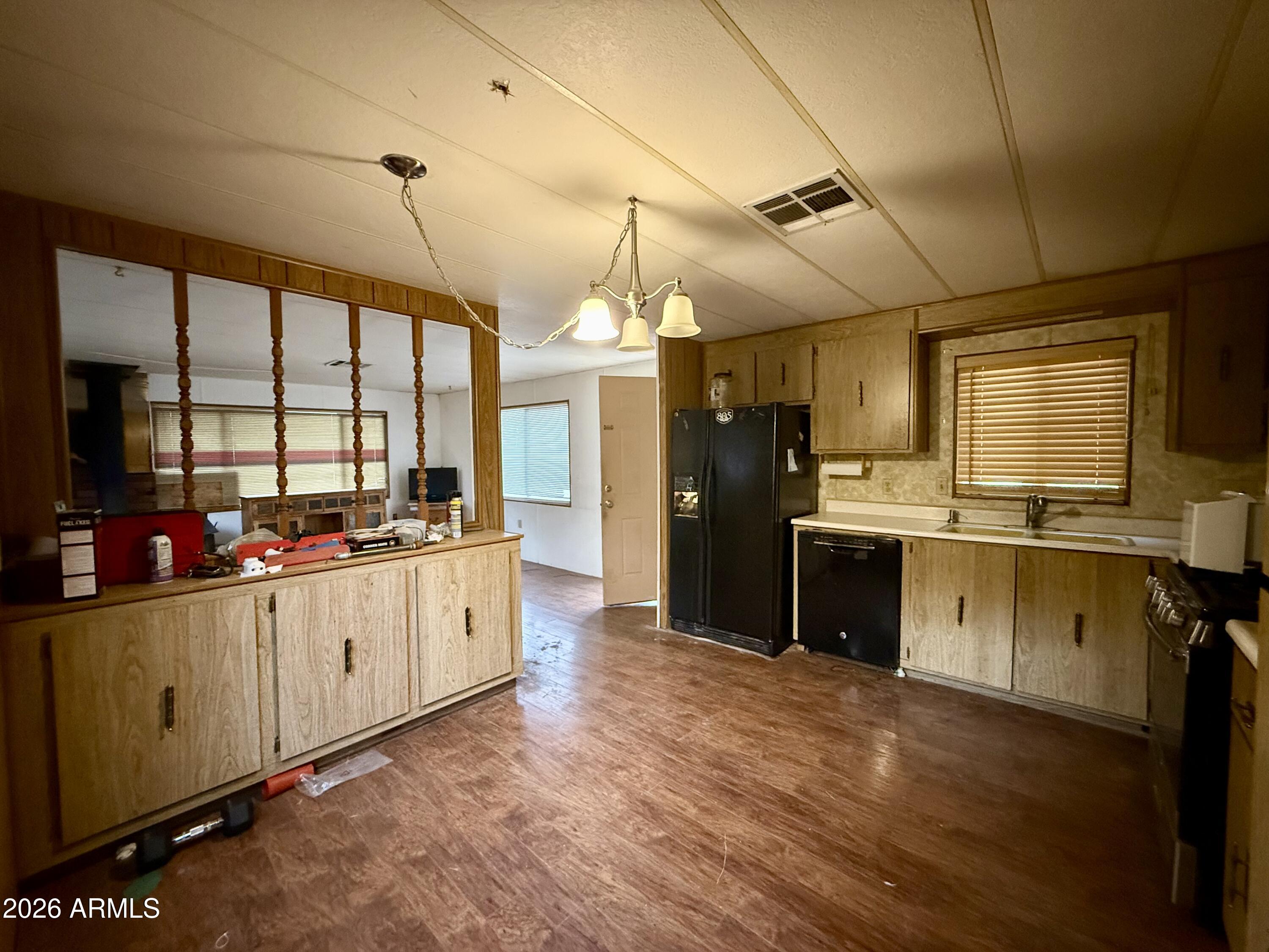 2953 Wildcat Trail Overgaard, AZ 85933 - Photo 11 of 22 a large kitchen with cabinets and wooden floor