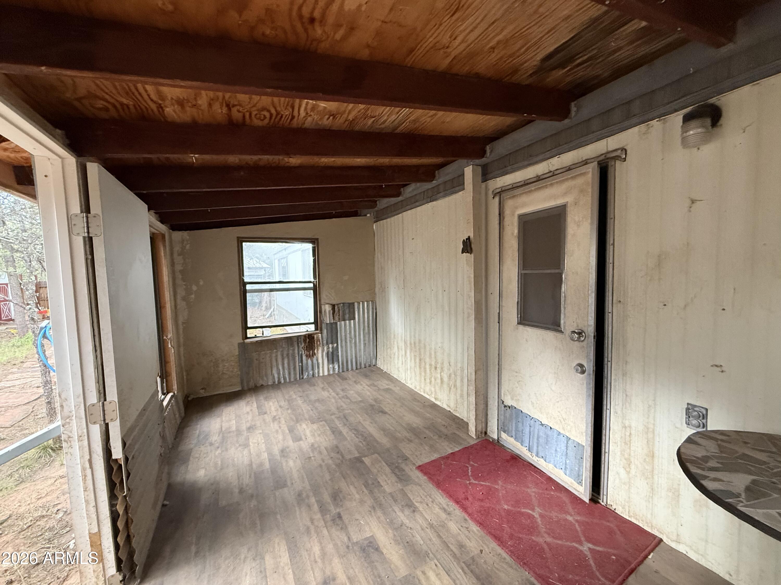 2953 Wildcat Trail Overgaard, AZ 85933 - Photo 13 of 22 a view of empty room with wooden floor and fan