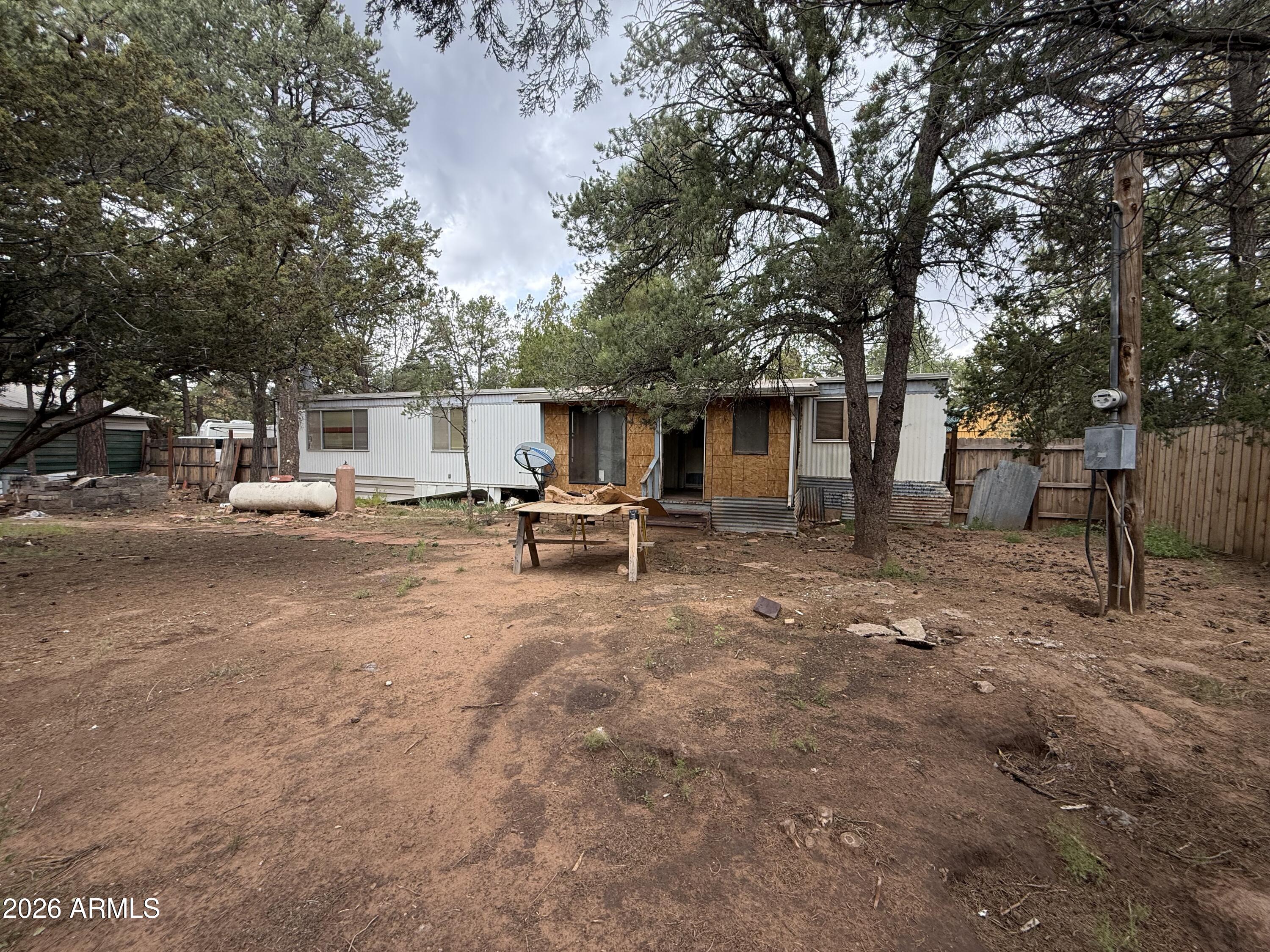 2953 Wildcat Trail Overgaard, AZ 85933 - Photo 17 of 22 a view of a house with backyard and sitting area