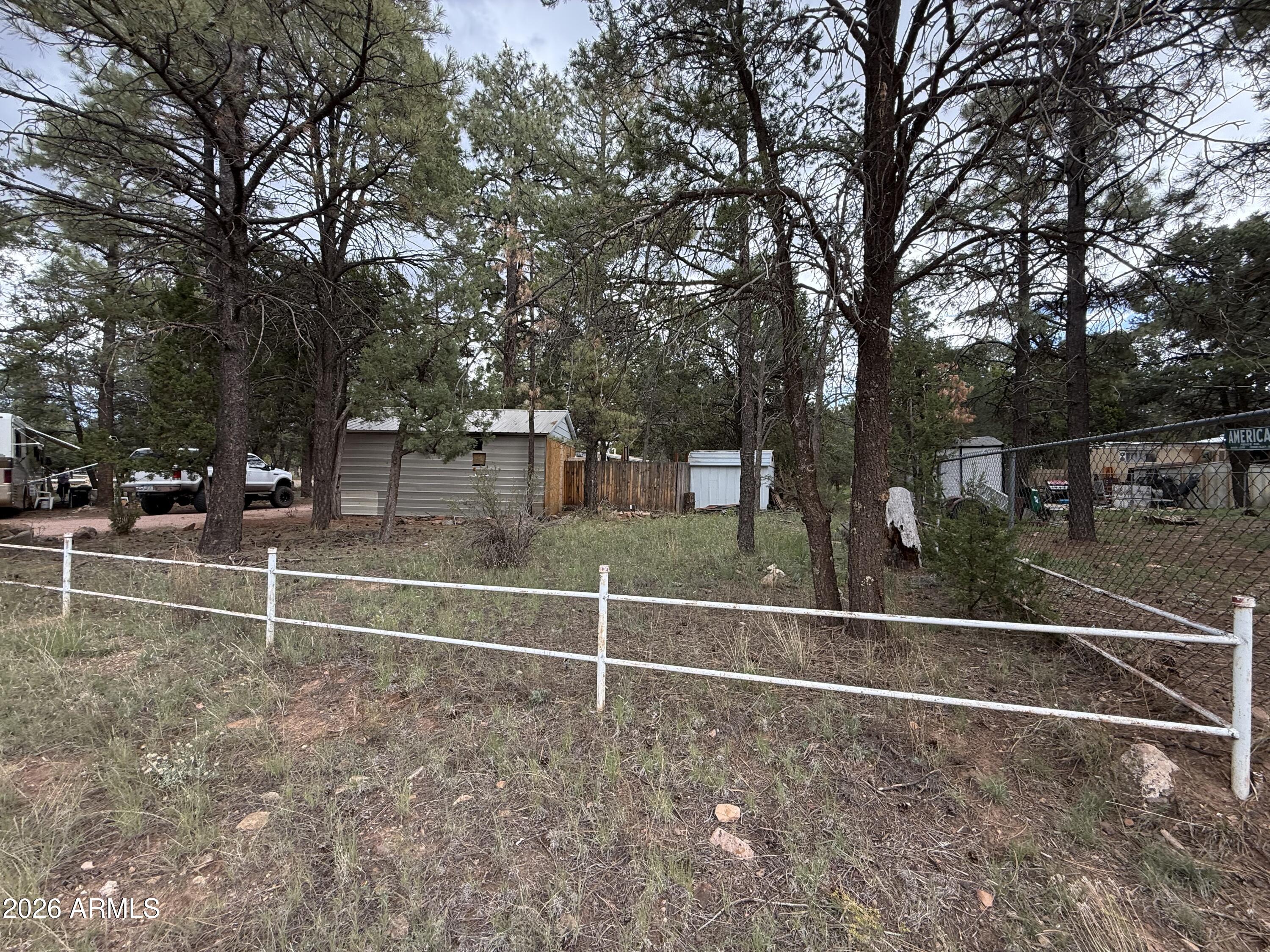 2953 Wildcat Trail Overgaard, AZ 85933 - Photo 22 of 22 a view of a yard with wooden fence