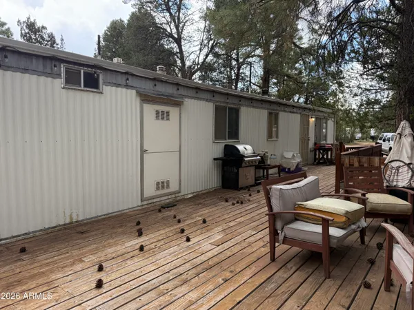 a backyard of a house with wooden floor yard and outdoor seating