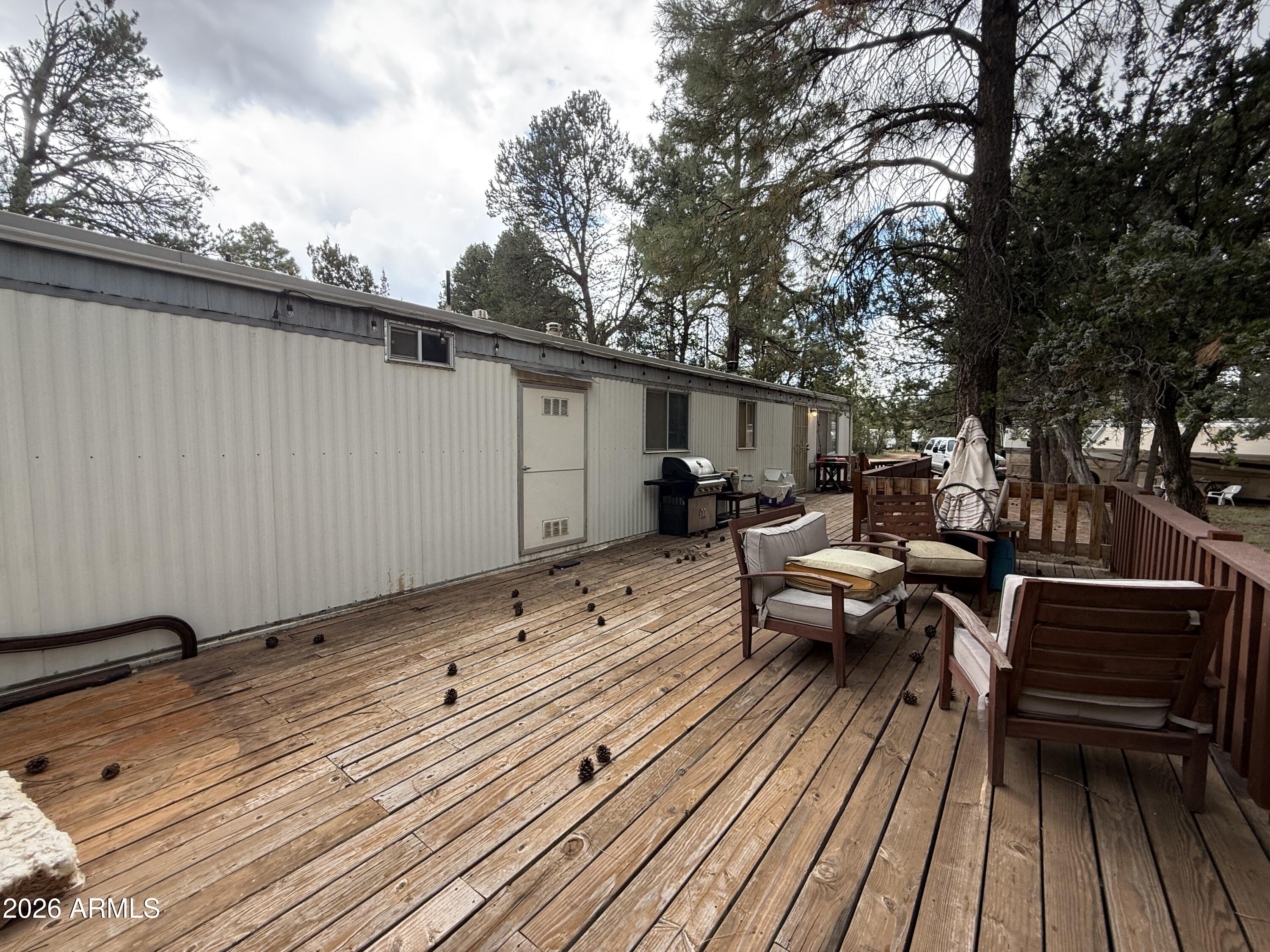 2953 Wildcat Trail Overgaard, AZ 85933 - Photo 6 of 22 a view of a roof deck with wooden floor and outdoor seating