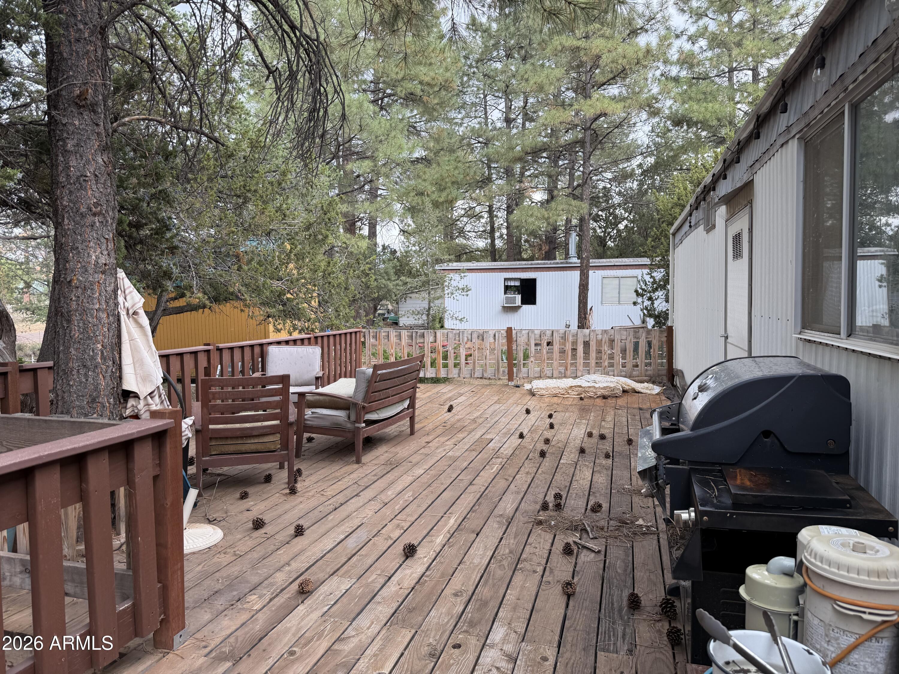 2953 Wildcat Trail Overgaard, AZ 85933 - Photo 8 of 22 a view of a patio with table and chairs and wooden floor