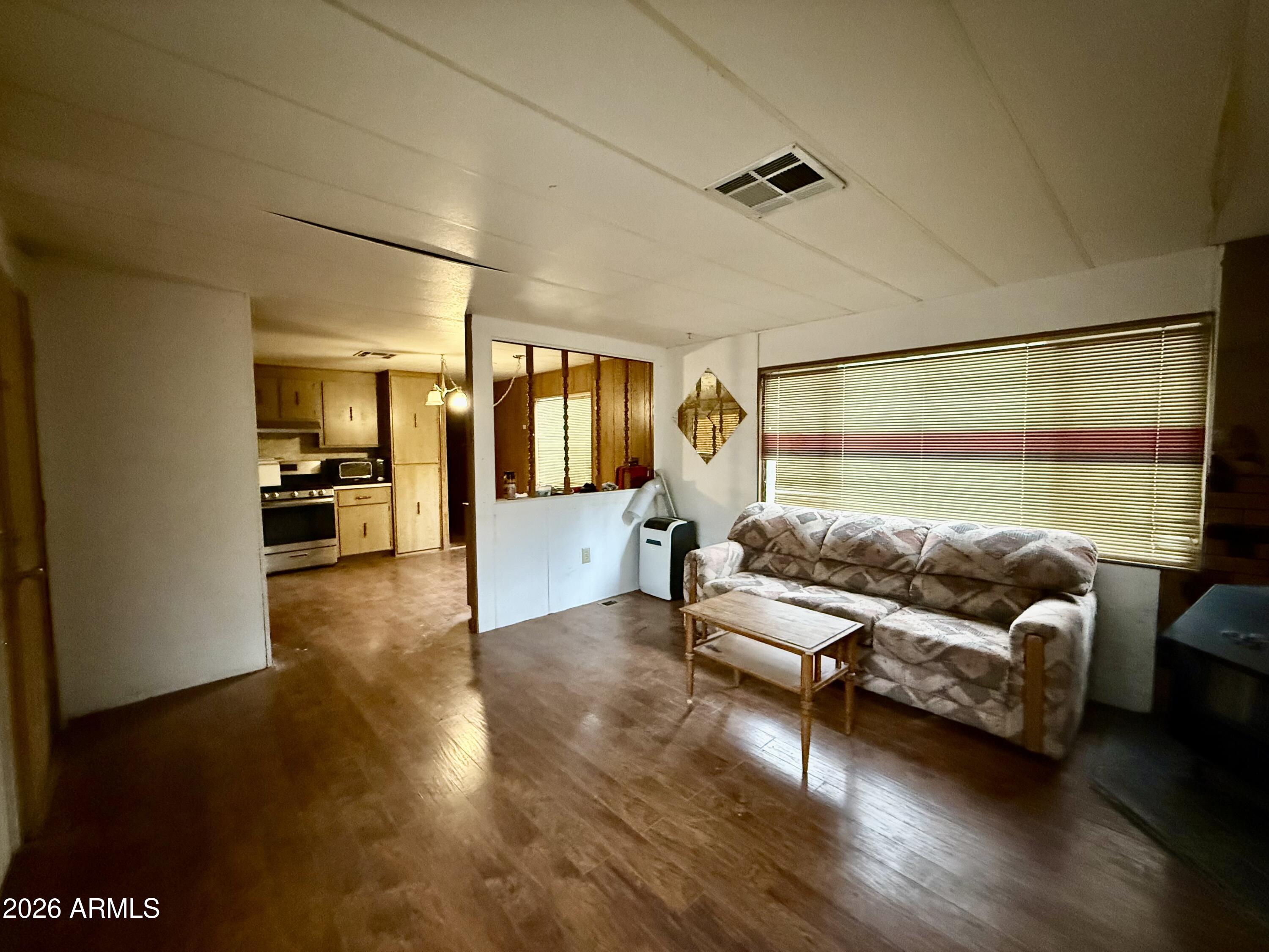 2953 Wildcat Trail Overgaard, AZ 85933 - Photo 9 of 22 a living room with furniture and a large mirror with wooden floor