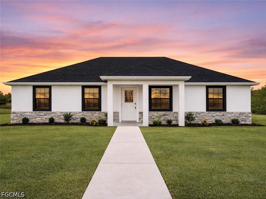7644 19th Terrace LaBelle, FL 33935 - Photo 1 of 12 a front view of house with yard and green space