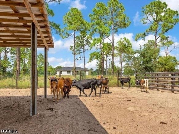 7644 19th Terrace LaBelle, FL 33935 - Photo 11 of 12 a view of a patio with a table chairs and a backyard